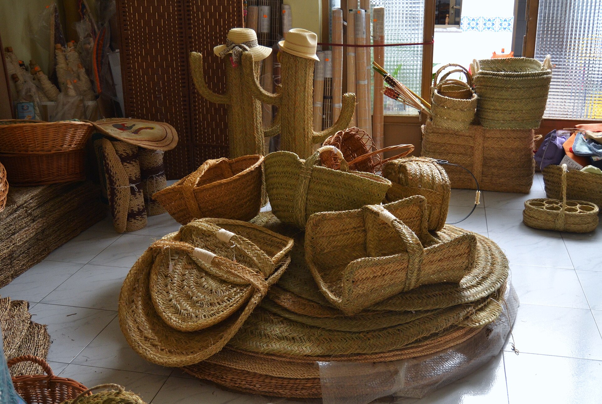 A small artisan shop interior, low light, mixed wood shelving with handmade objects