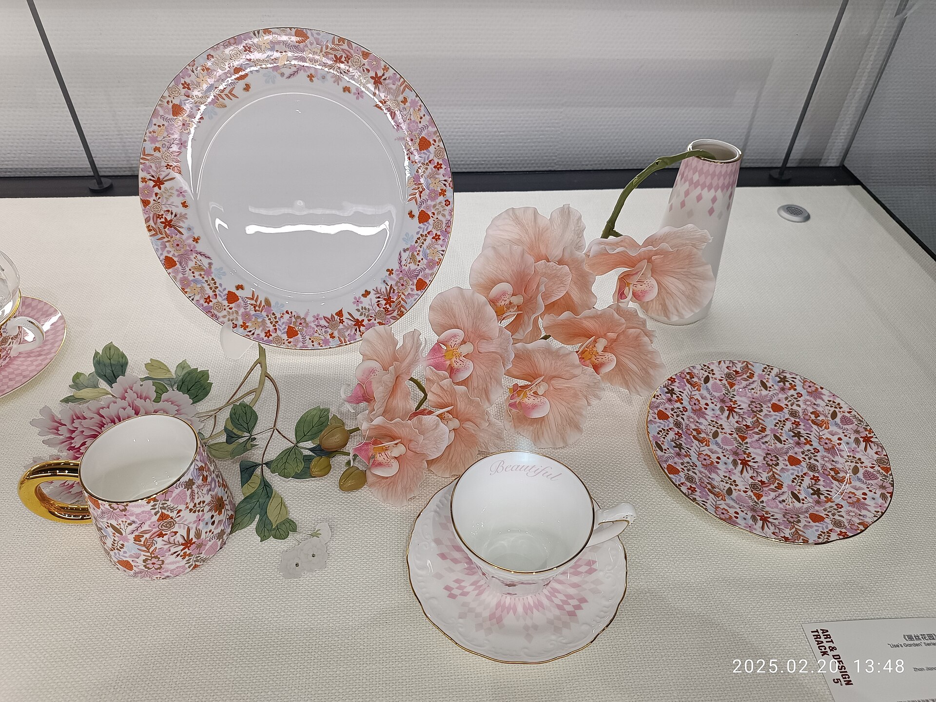 Ceramic table service shown in a museum-style display lighting