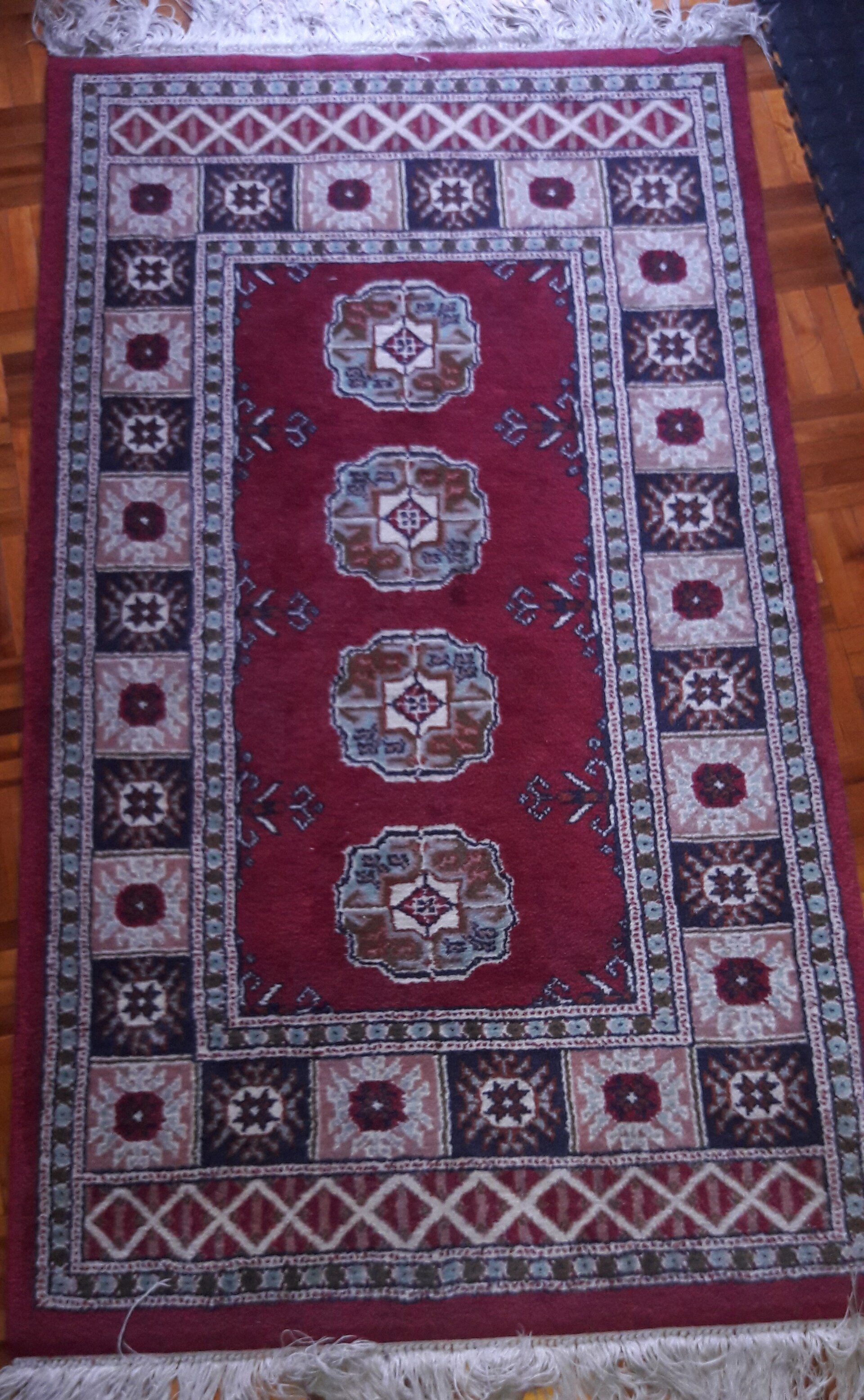 A handwoven rug positioned in flat studio light to show pattern and weight