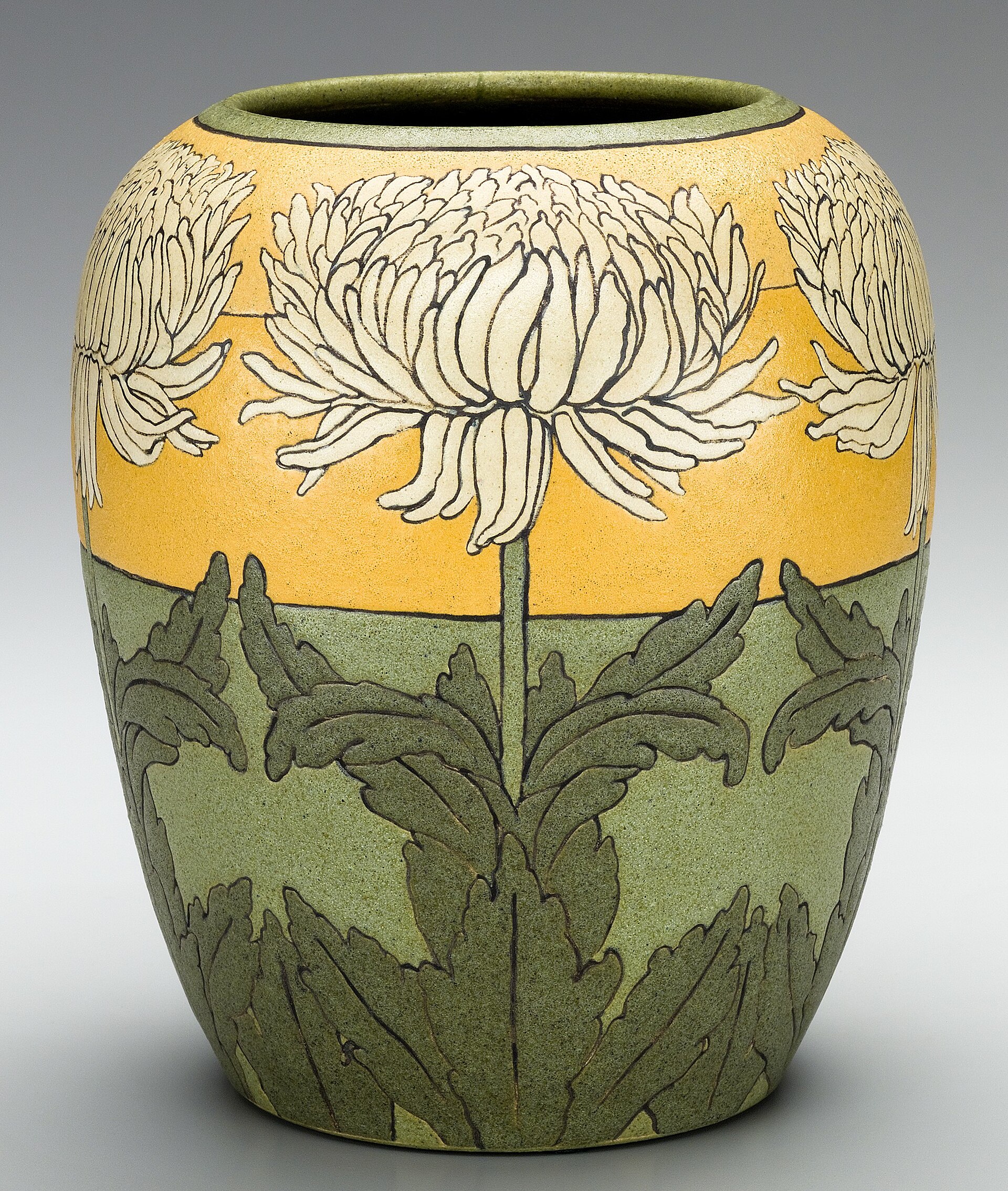 A tall stoneware vase on a neutral surface, photographed straight on
