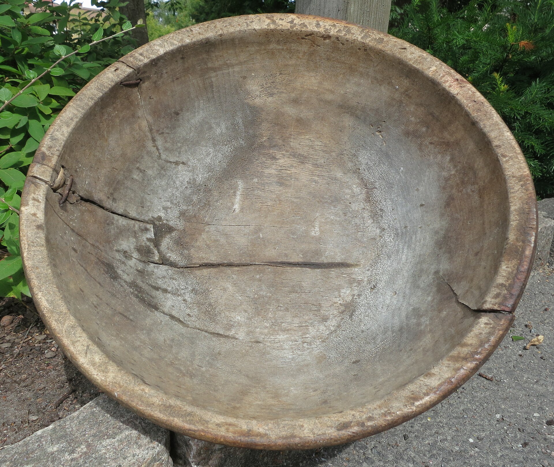 An oiled wooden bowl with grain visible across its rim